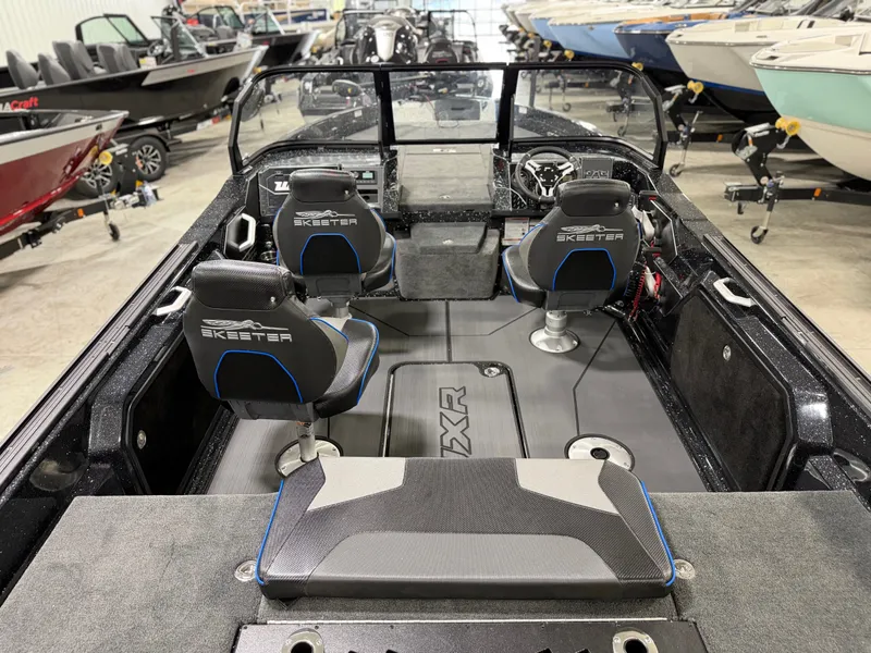 Slide: The Image of The image shows the interior of a Skeeter WXR2060 boat with two seats and a helm. - 31