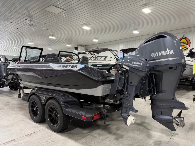 Slide: The Image of A 2026 Skeeter WXR2060 boat in a showroom, featuring a Yamaha outboard motor. - 6