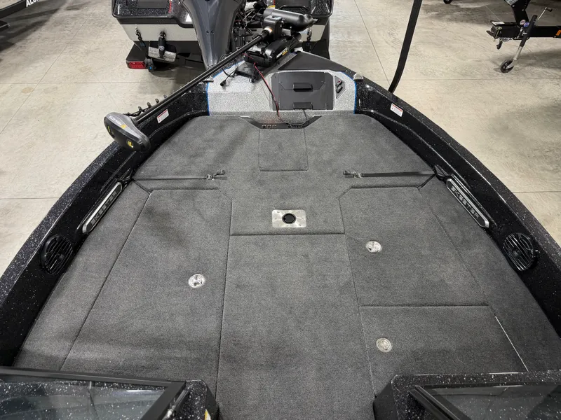 Slide: The Image of The image shows the deck of a 2026 Skeeter WXR2060 boat with gray carpeting. - 12