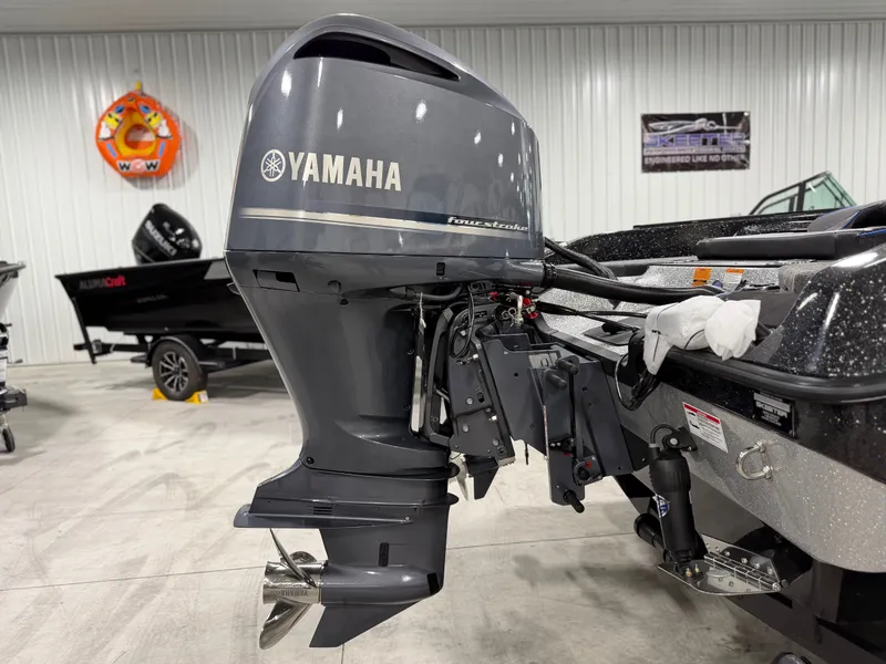 Slide: The Image of A Yamaha outboard motor is attached to a boat in a showroom setting. - 9