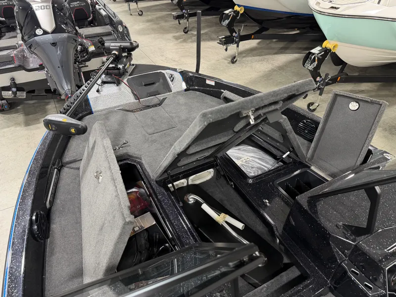 Slide: The Image of The image shows the interior of a Skeeter WXR2060 boat with open storage compartments. - 13