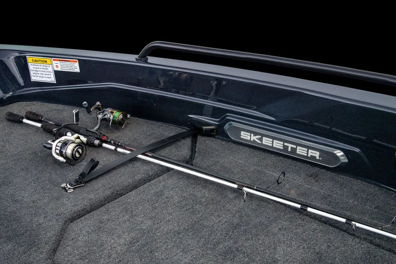 Slide: The Image of Fishing rods lie on the floor of a boat with Skeeter logo. - 43