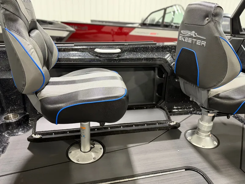 Slide: The Image of Two cushioned seats in a modern boat with gray flooring and blue accents. - 20