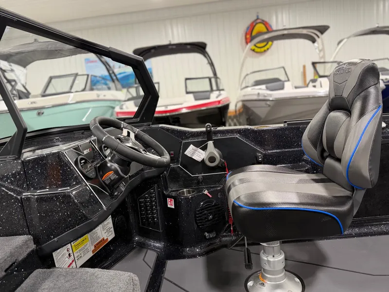Slide: The Image of The image shows the cockpit of a Skeeter WXR2060 boat with a padded seat and steering. - 21