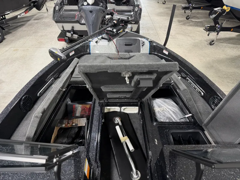 Slide: The Image of The image shows the interior of a Skeeter WXR2060 boat with storage compartments and equipment. - 14