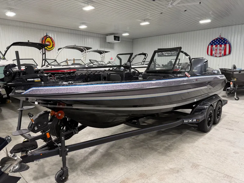 Slide: The Image of A 2026 Skeeter WXR2060 boat on a trailer in a showroom. - 4