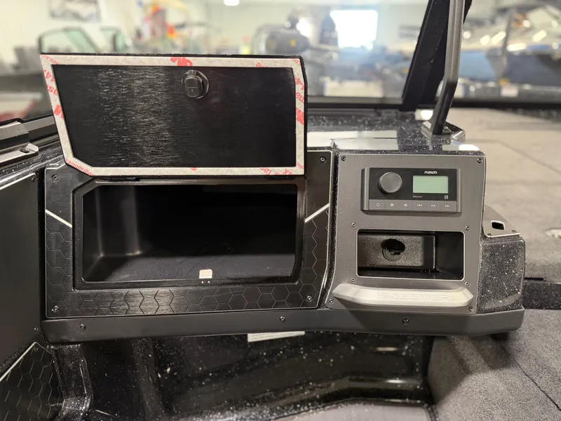 Slide: The Image of The image shows the dashboard of a Skeeter WXR2060 boat with a radio and storage compartment. - 18