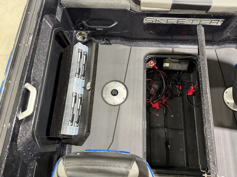 Slide: The Image of The image shows the interior of a Skeeter WXR2060 boat with a battery compartment and seating area. - 28