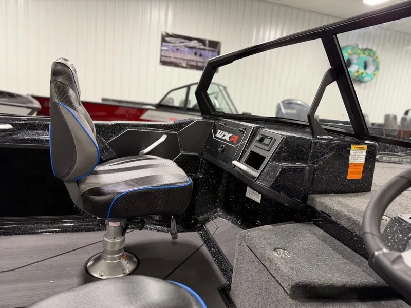 Slide: The Image of The image shows the cockpit of a Skeeter WXR2060 boat with a swivel seat and control console. - 16
