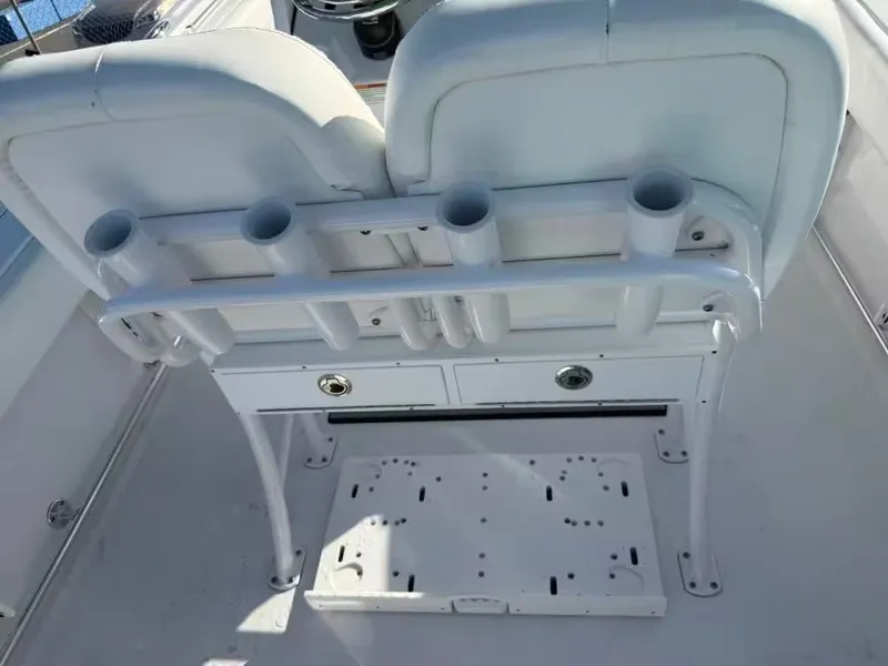 Slide: The Image of Rear view of white boat seats with built-in rod holders and storage. - 8