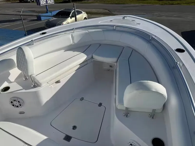 Slide: The Image of The image shows the bow area of a Sportsman Open 232 Center Console boat with white seating. - 18