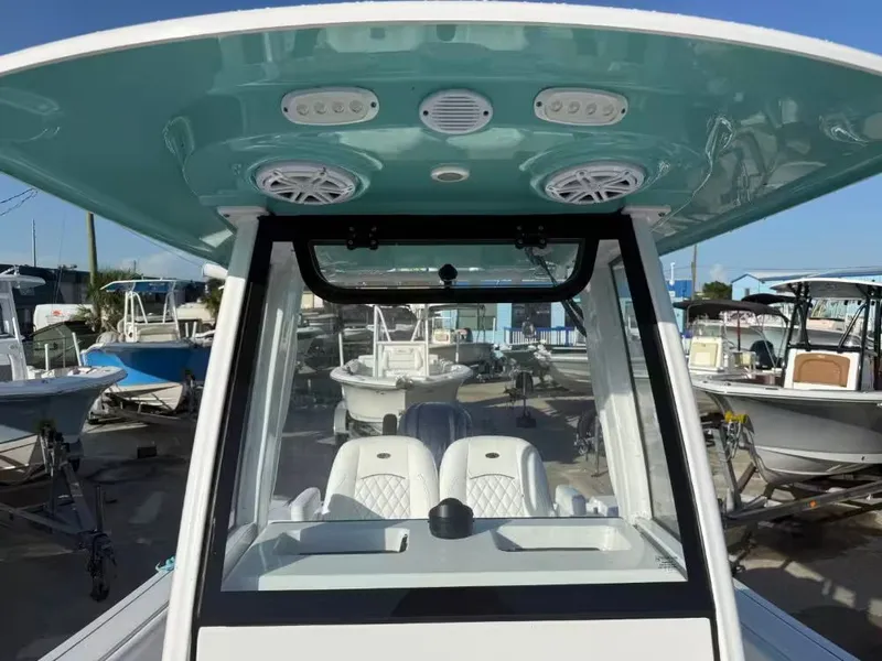 Slide: The Image of 2025 Sportsman Open 232 Center Console with turquoise roof and modern speakers. - 14