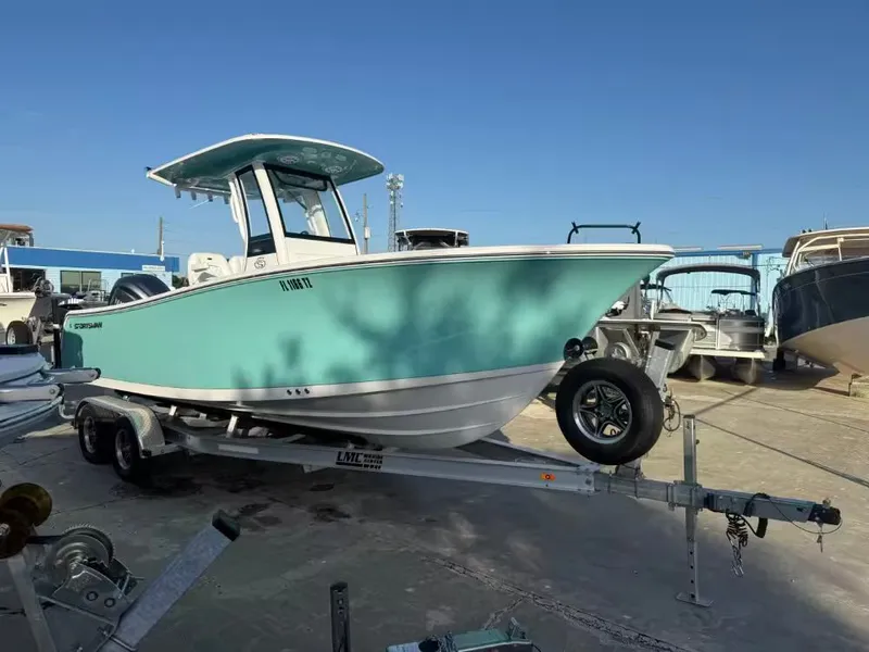 Slide: The Image of A turquoise 2025 Sportsman Open 232 Center Console on a trailer outdoors. - 4