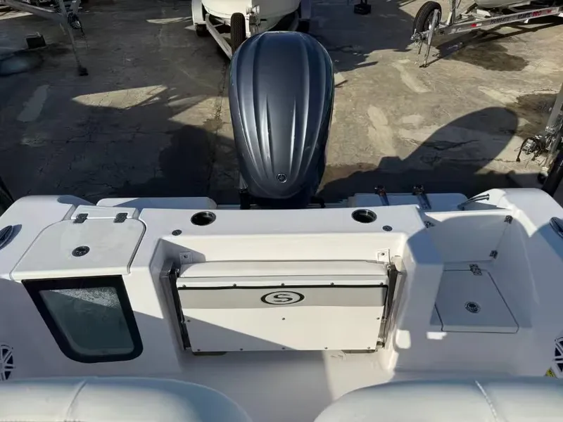 Slide: The Image of The image shows the stern of a Sportsman Open 232 Center Console boat with an outboard motor. - 6