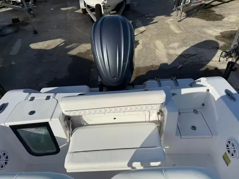 Slide: The Image of The image shows the stern of a Sportsman Open 232 Center Console boat with an outboard motor. - 7