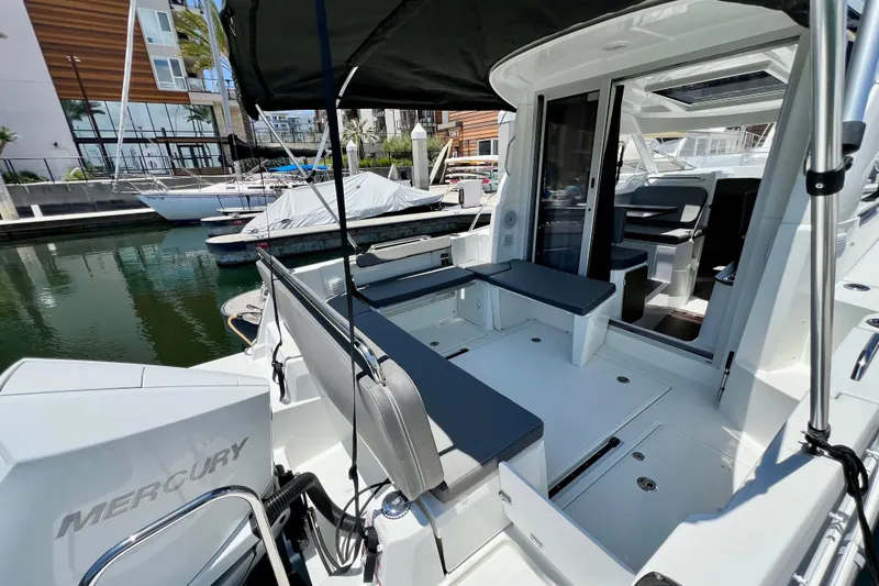 Slide: The Image of 2023 Beneteau Antares 8 boat interior with seating, docked in a marina. - 31