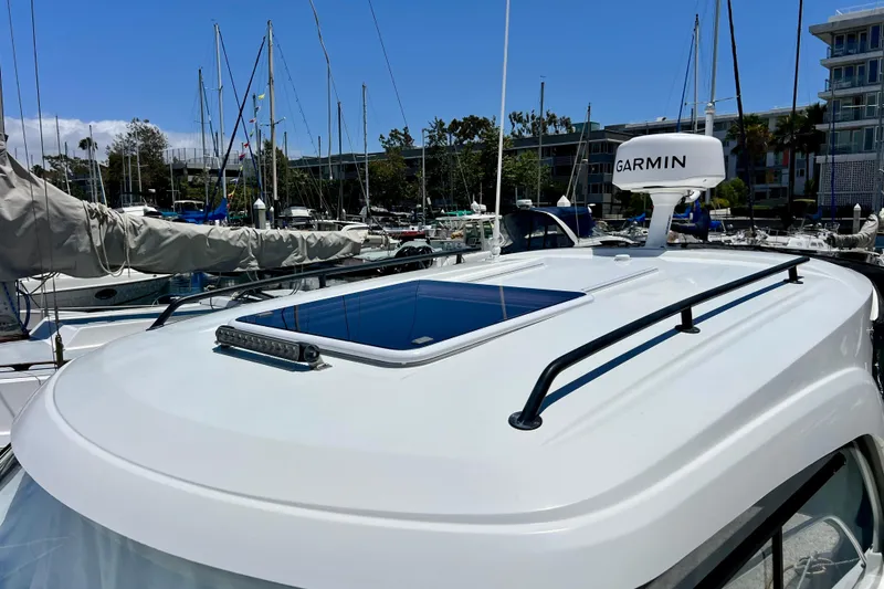 Slide: The Image of 2023 Beneteau Antares 8 boat with Garmin radar, docked in a marina. - 25