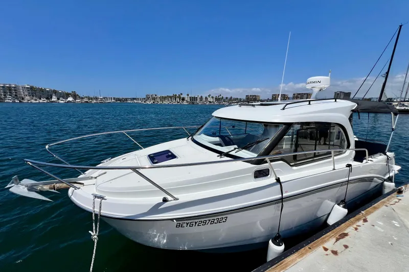 Slide: The Image of 2023 Beneteau Antares 8 docked in a marina under a clear blue sky. - 17