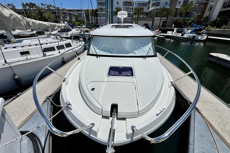 Slide: The Image of 2023 Beneteau Antares 8 docked in marina, showcasing sleek design and modern features. - 21
