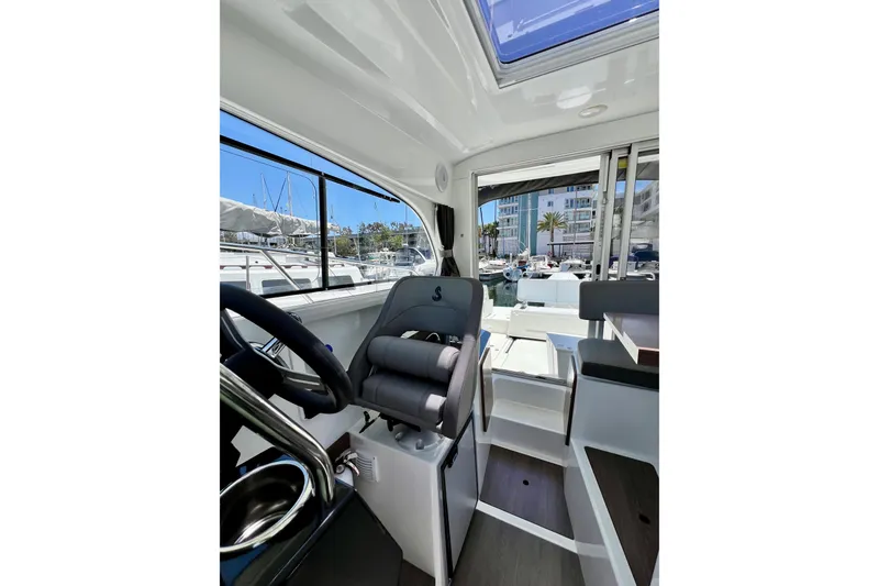 Slide: The Image of Interior view of 2023 Beneteau Antares 8 boat, featuring helm and seating area. - 77