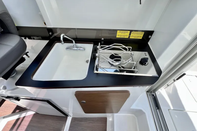 Slide: The Image of 2023 Beneteau Antares 8 boat kitchen with sink and stove. - 63