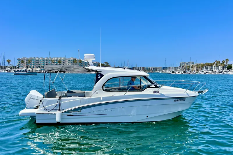 Slide: The Image of 2023 Beneteau Antares 8 boat cruising in a marina under clear blue skies. - 5
