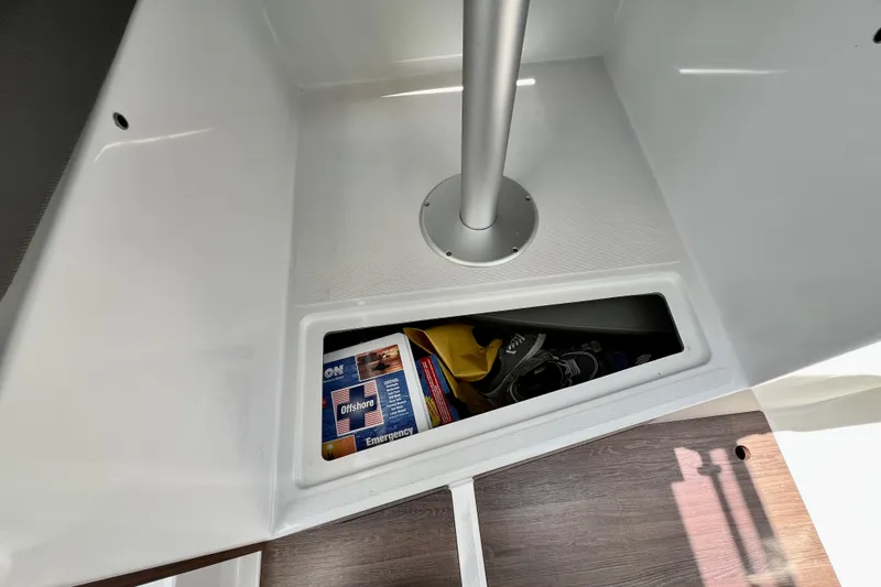 Slide: The Image of Storage compartment in 2023 Beneteau Antares 8 boat, featuring emergency supplies and personal items. - 67