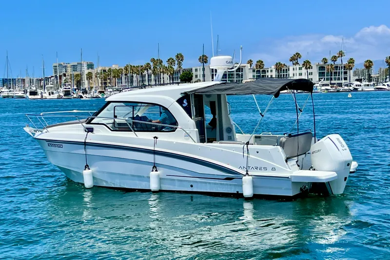 Slide: The Image of 2023 Beneteau Antares 8 boat on water, marina background, sunny day. - 10