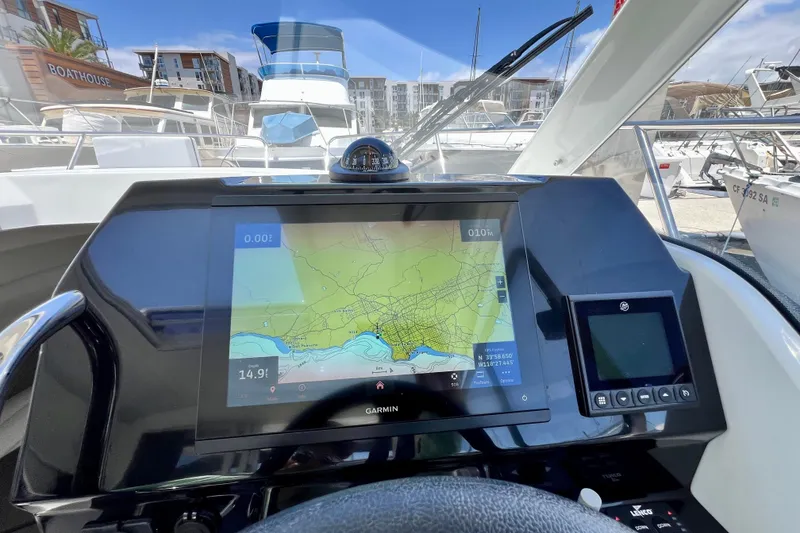 Slide: The Image of Cockpit view of 2023 Beneteau Antares 8 with navigation display and compass. - 55