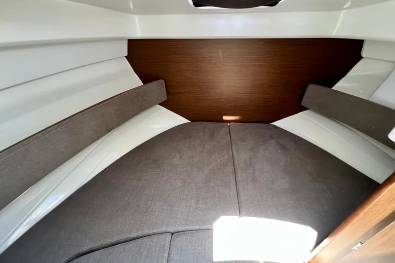 Slide: The Image of 2023 Beneteau Antares 8 cabin interior with cozy gray cushions and wooden accents. - 73