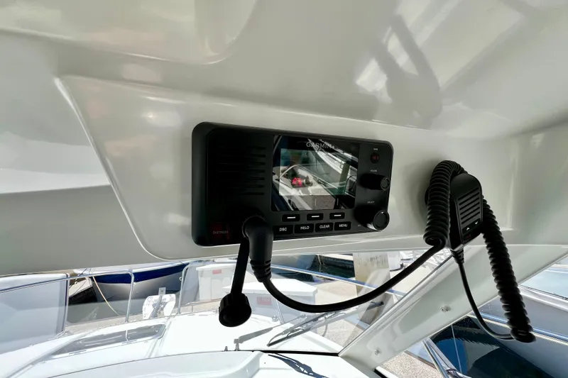 Slide: The Image of 2023 Beneteau Antares 8 boat dashboard with Garmin marine radio and microphone. - 57