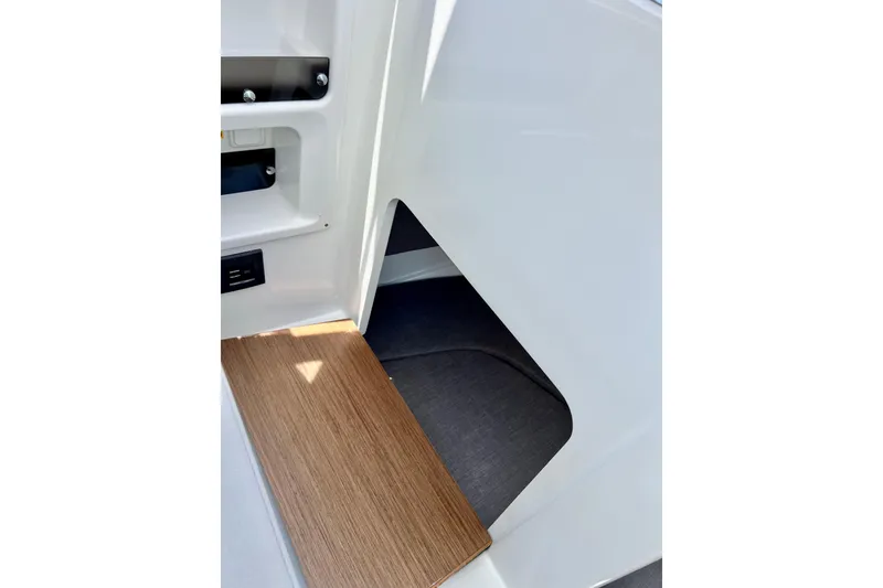 Slide: The Image of Interior view of 2023 Beneteau Antares 8, featuring sleek white surfaces and wooden flooring. - 51