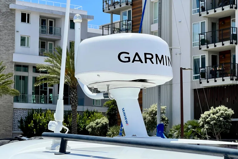 Slide: The Image of Garmin radar on 2023 Beneteau Antares 8 boat, with modern buildings in background. - 26