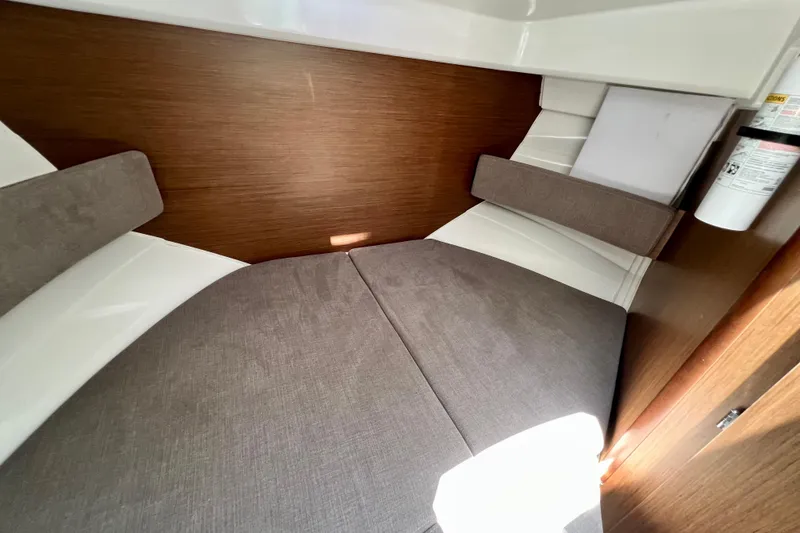 Slide: The Image of 2023 Beneteau Antares 8 cabin interior with cushioned seating and wooden paneling. - 74