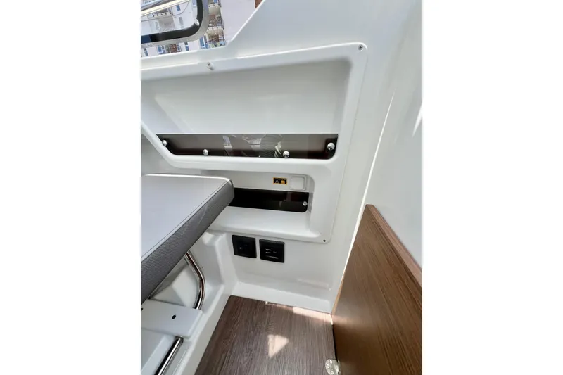 Slide: The Image of Interior view of 2023 Beneteau Antares 8, showcasing seating and control panel details. - 50