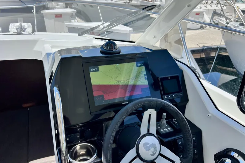 Slide: The Image of Cockpit of 2023 Beneteau Antares 8 with navigation display and steering wheel. - 54
