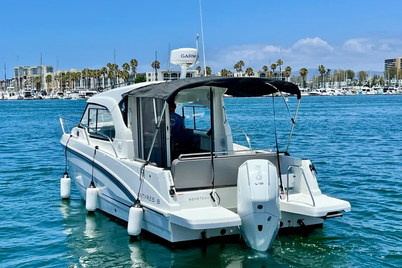 Slide: The Image of 2023 Beneteau Antares 8 boat on water, marina background, sunny day. - 9