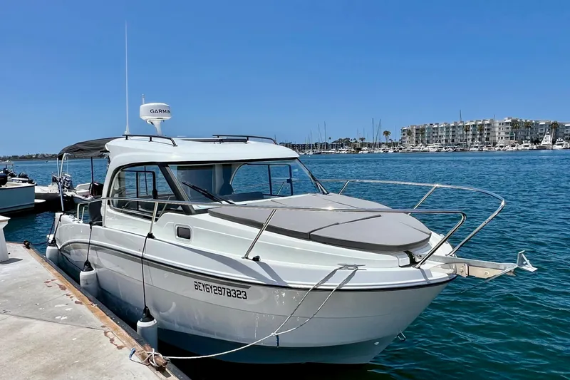 Slide: The Image of 2023 Beneteau Antares 8 docked at marina, clear blue sky and water. - 11