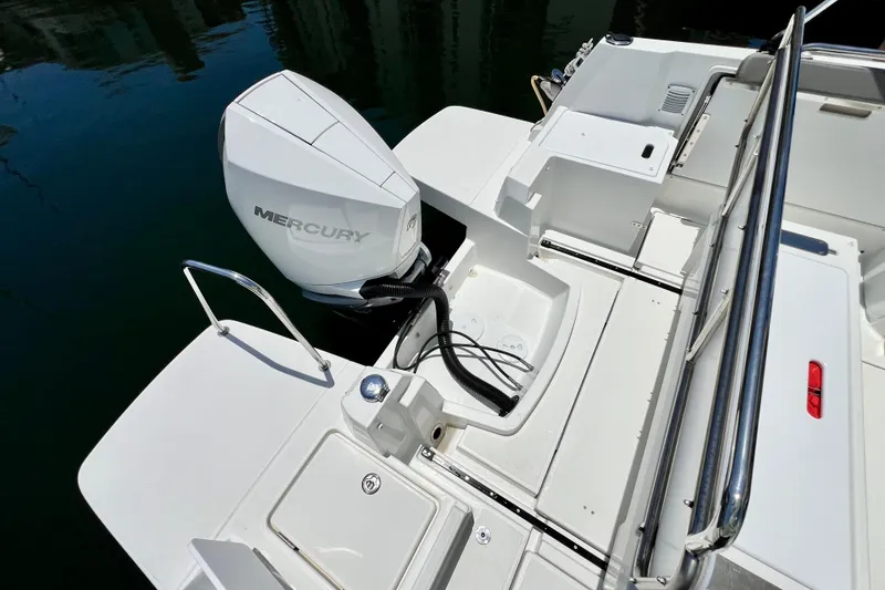 Slide: The Image of 2023 Beneteau Antares 8 boat with Mercury outboard engine, docked on calm water. - 40