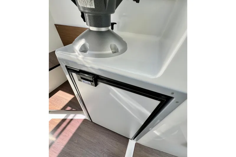 Slide: The Image of 2023 Beneteau Antares 8 interior with compact refrigerator and modern design. - 68