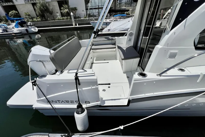 Slide: The Image of 2023 Beneteau Antares 8 boat docked, showcasing sleek design and spacious deck area. - 20