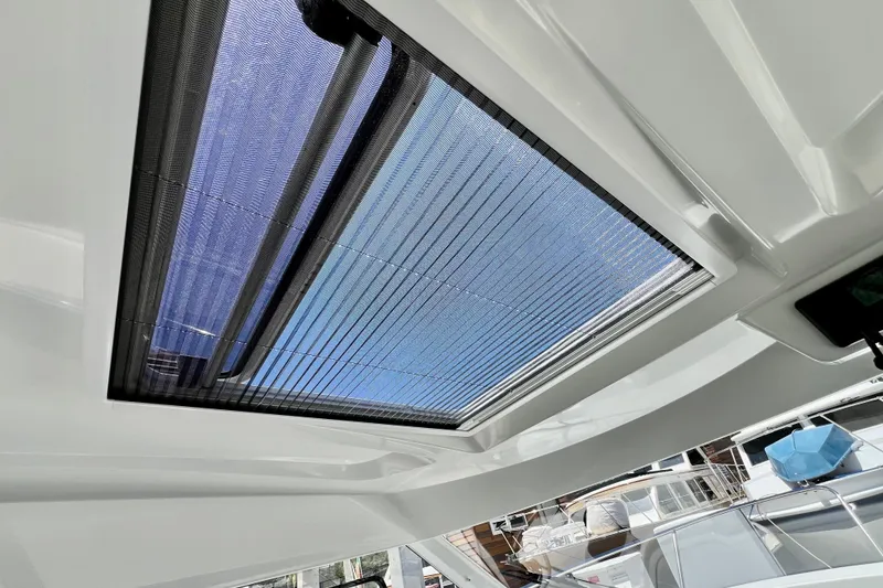 Slide: The Image of 2023 Beneteau Antares 8 boat interior with sunroof, showcasing modern design and natural light. - 65