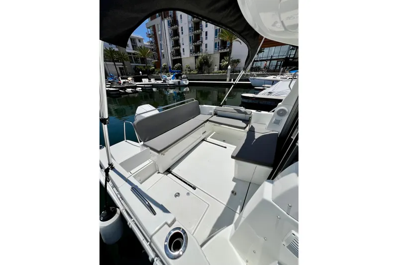Slide: The Image of 2023 Beneteau Antares 8 boat interior with seating, docked in a marina. - 28