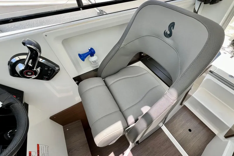 Slide: The Image of Captain's seat in 2023 Beneteau Antares 8 boat, featuring modern controls and sleek design. - 61