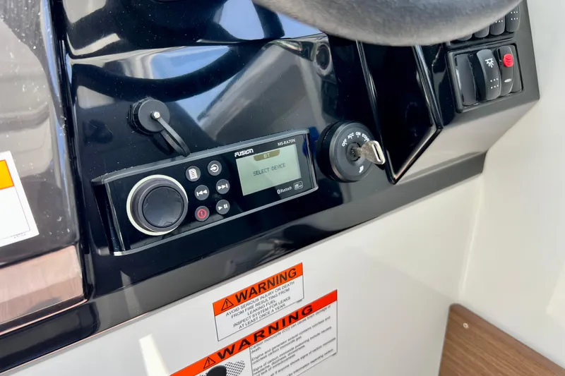 Slide: The Image of Control panel of 2023 Beneteau Antares 8 boat with Fusion audio system and ignition key. - 59