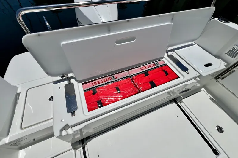 Slide: The Image of 2023 Beneteau Antares 8 boat storage with red life jackets neatly organized. - 39