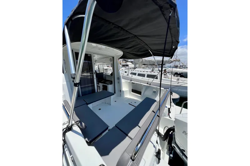 Slide: The Image of 2023 Beneteau Antares 8 boat with shaded deck and seating area in marina. - 32