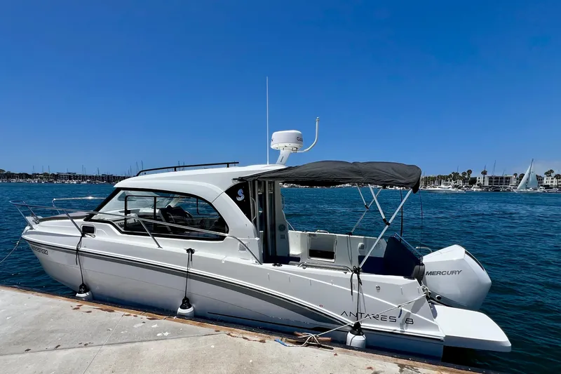 Slide: The Image of 2023 Beneteau Antares 8 boat docked at marina under clear blue sky. - 15