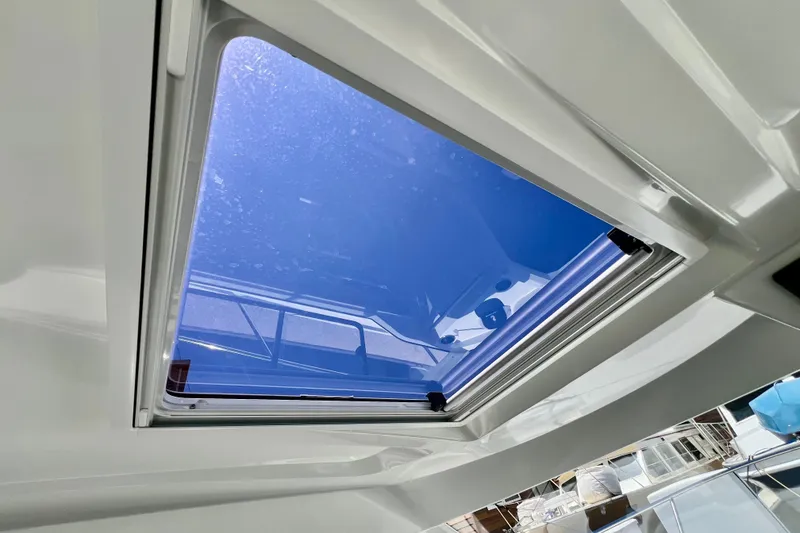 Slide: The Image of Skylight view from 2023 Beneteau Antares 8, showcasing clear blue sky. - 64