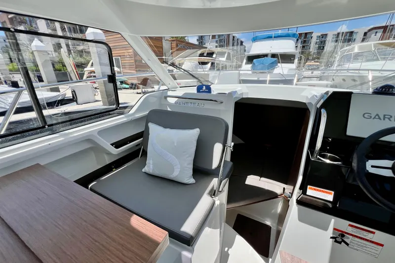 Slide: The Image of Interior of 2023 Beneteau Antares 8 boat, featuring seating and helm station. - 46